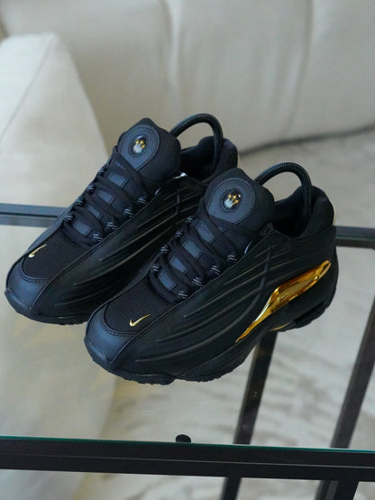 NIKE NOCTA STEP 2 NEGRO DORADO
