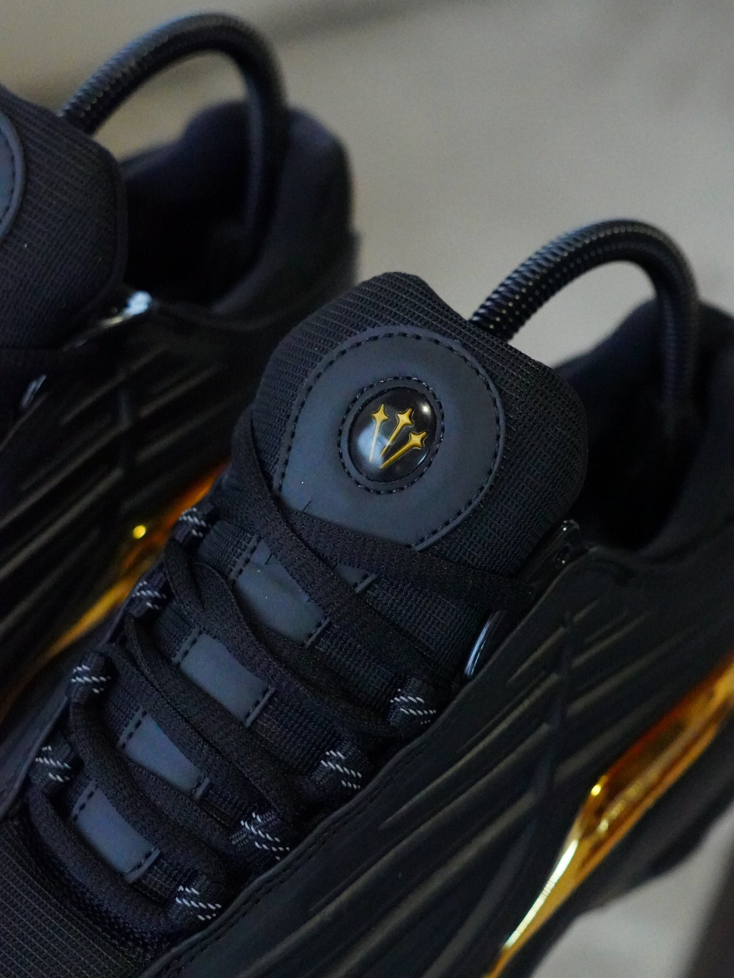 NIKE NOCTA STEP 2 NEGRO DORADO