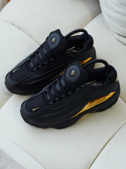 NIKE NOCTA STEP 2 NEGRO DORADO